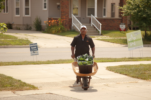 An area resident brings produce to sell at the South Side farmers market organized by Our Kitchen Table.