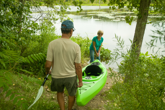 Fred and Carole Nolten bring their kayak onto the Thornapple River using the Paul Henry Thornapple Trail.