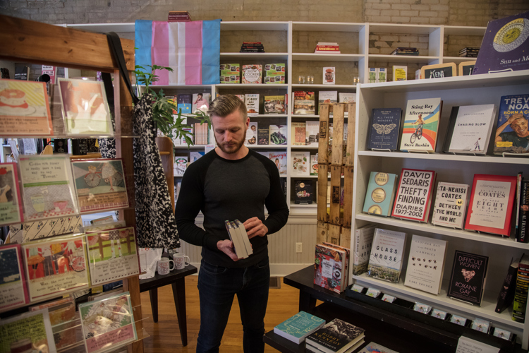 Christopher Roe goes through inventory in his bookstore Books and Mortar.