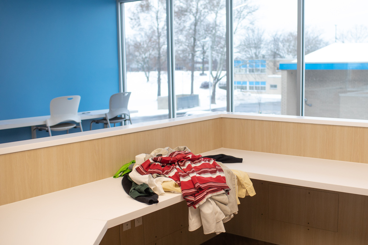 A stack of donated shirts waits to be sorted and distributed. 