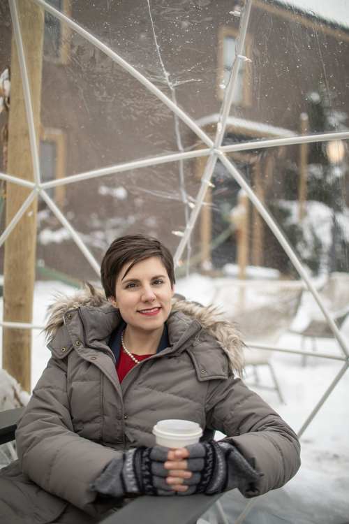 Justsine Burdette enjoys a warm coffee in a geodesic dome at Outdoor Coffee, one of Grand Rapid's unique attractions.