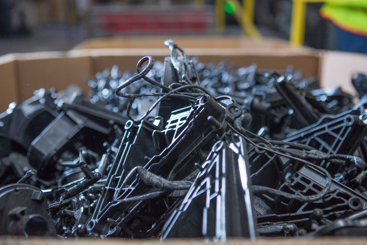 Pallets, cut offs, and other materials are put into a grinding machine to be turned into small pieces of plastic to be recycled. 