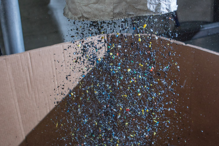 Ground up pieces of plastic fill a large container to be shipped to a melting facility. 