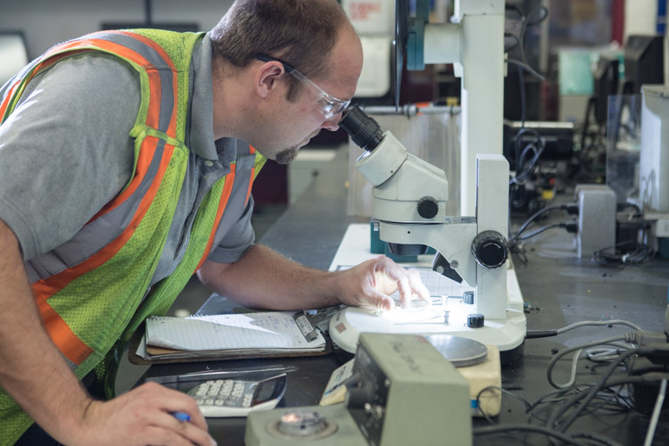 Plastics are tested by Matt Jabaay for composition to determine how they are sorted to be recycled. 