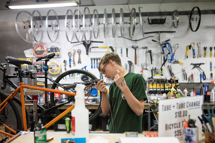 Ray Gardener repairs a bicycle at Switchback Gear Exchange.