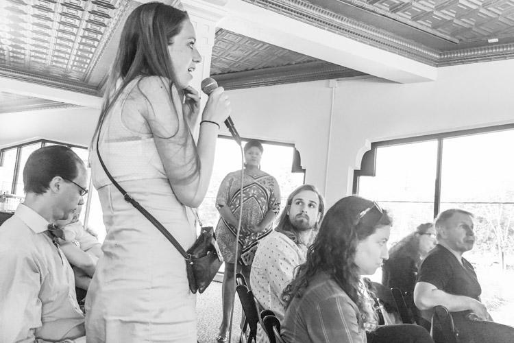 Audience members ask the panelists questions. 