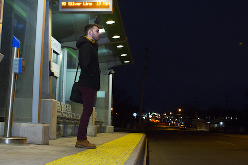 Ulloa waits for the Silverline bus going north on his daily commute to work. 