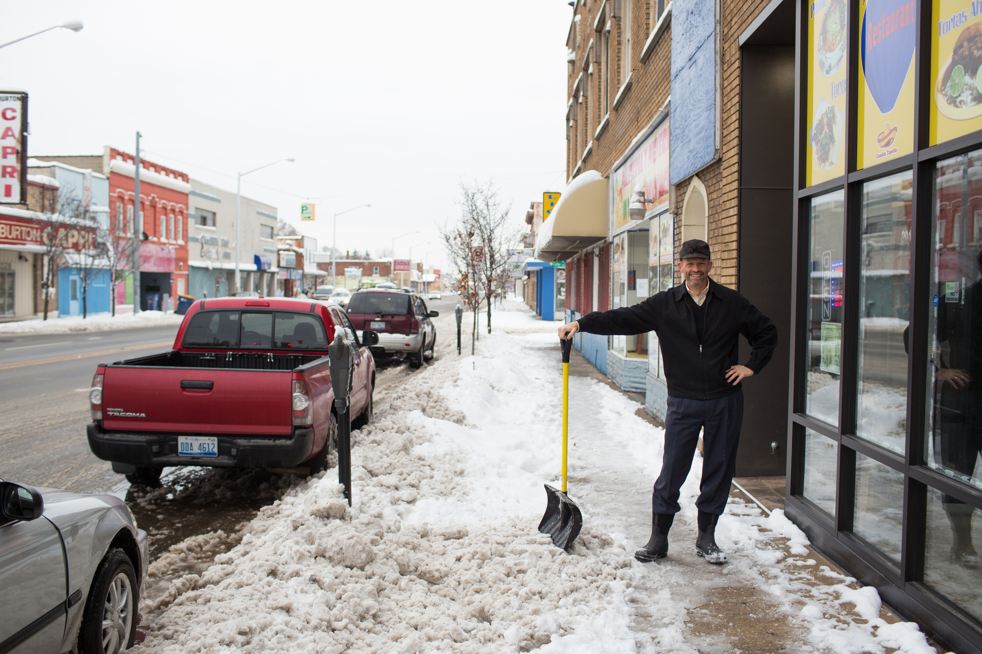 Van Drunen shovels the front of his building on 2019 S. Division, a retail spsace he rents to El Globo Restaurante.