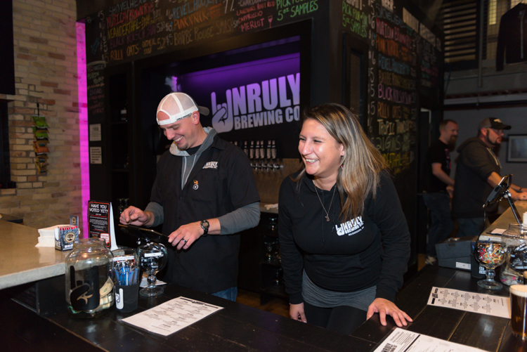 Unruly Brewing's Justin and Leeza joke with customers. Photo by Jenna Swartz