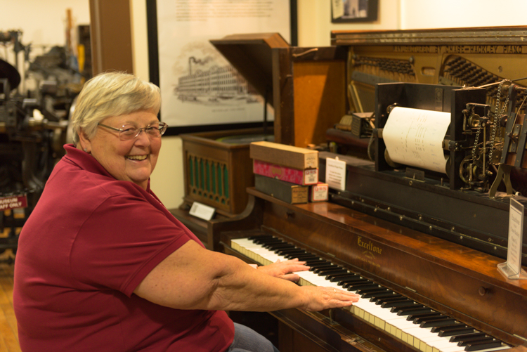 Anne Dake shows off her player piano skills on this instrument manufactured by Chase Hackley in Muskegon.
