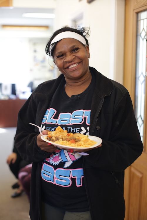 Sony Eadmon, resident of the Grandville Avenue, shows off her plate of delicious food. 