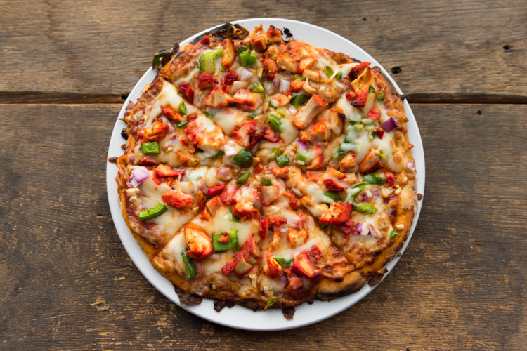 The butter chicken naan pizza.