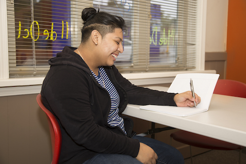 Erica Tomas Juarez practices her writing skills at the Cook Library Center. 