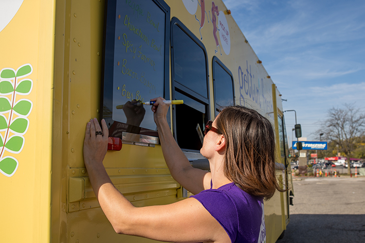 Abbie Sterling writes out her menu on the side of her food truck.
