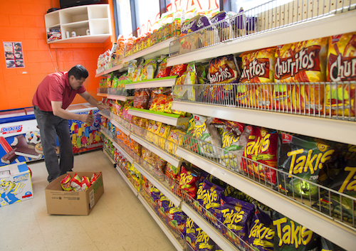 Velazquez Ramirez stocks up the aisles with Productos Diana, snack products from Central America, at Xela Store