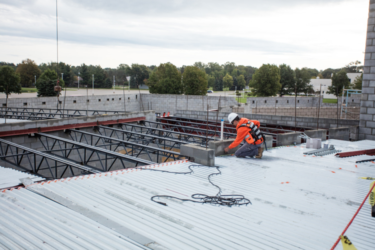 Workers assemble roof structures for the new Jenison Public School's Early Childhood Learning Center and Spanish Immersion Program.