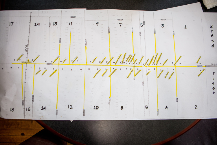 A map shows the historic business district on Leonard densely populated with stores. 