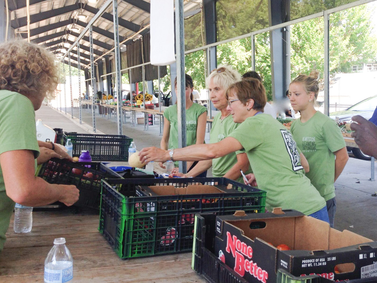 Volunteers prepare produce to be distributed. 