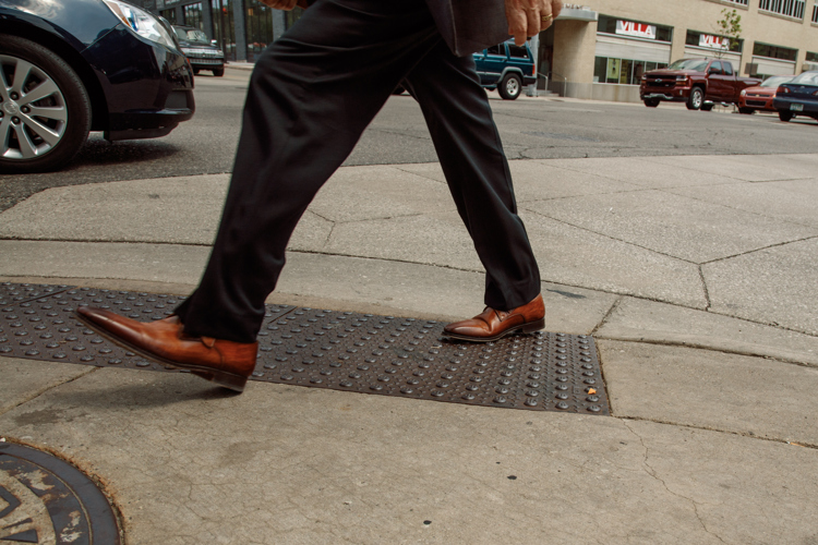 Tactile cast iron tiles help warn pedestrians of the roadway.