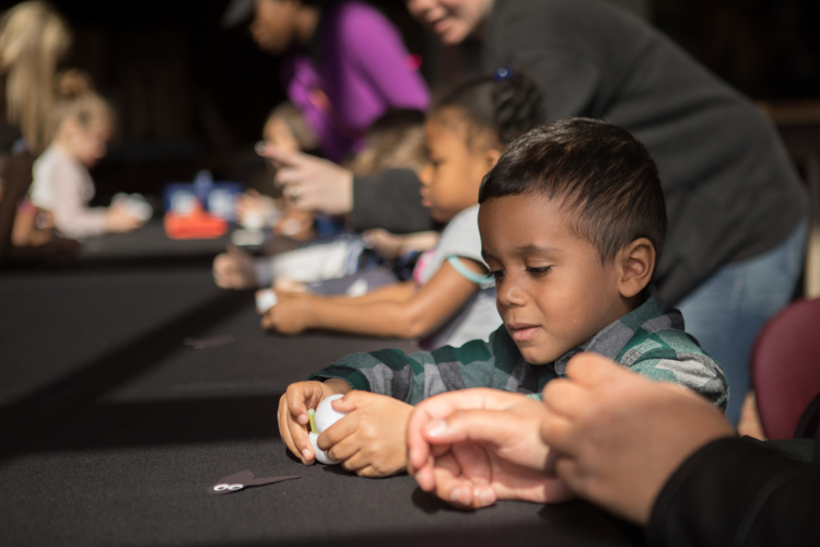 Students make fireflies while learning about bioluminescence.