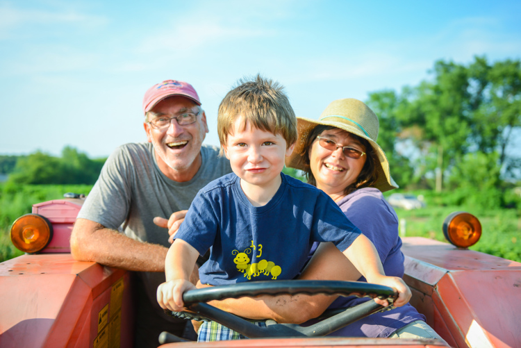 Groundswell Farm owners Katie Brandt and Tom Cary their son, Leland. Photo by Sara Cozolino Photography