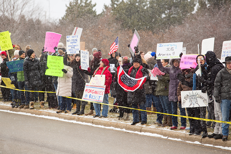 Protestors gather at the Gerald R. Ford Airport to protest the immigration order.