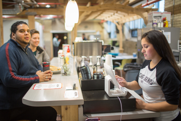 Area youth run the coffee shop, temporarily in the CCT's offices.