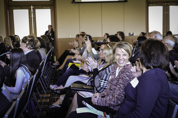 Spectators watch the business pitches.
