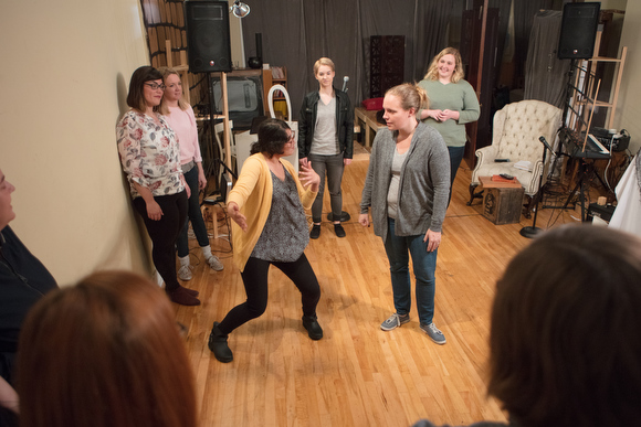 Funny Girls do improv games together to sharpen their skills.