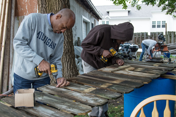 Community member helps other signs to help indicate on the ground what is planted. 