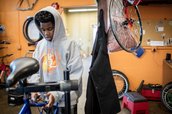 Mike Poliak works on his bike in a workshop used for classes on repair.