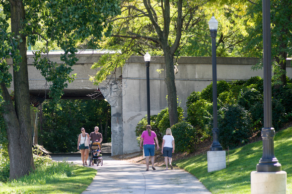 People enjoy the path along the river, soon to join more trail systems.