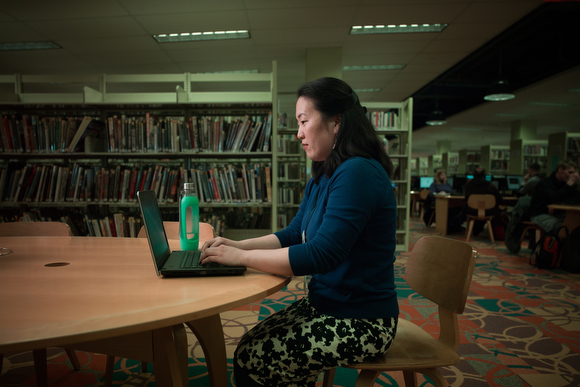 Tricia Glaser uses free wifi at the Grand Rapids Public Library.