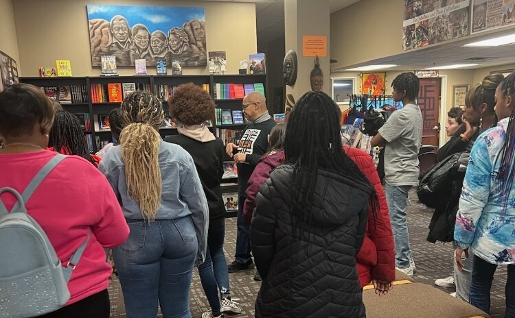 Student listen to a presentation at GRAAMA.