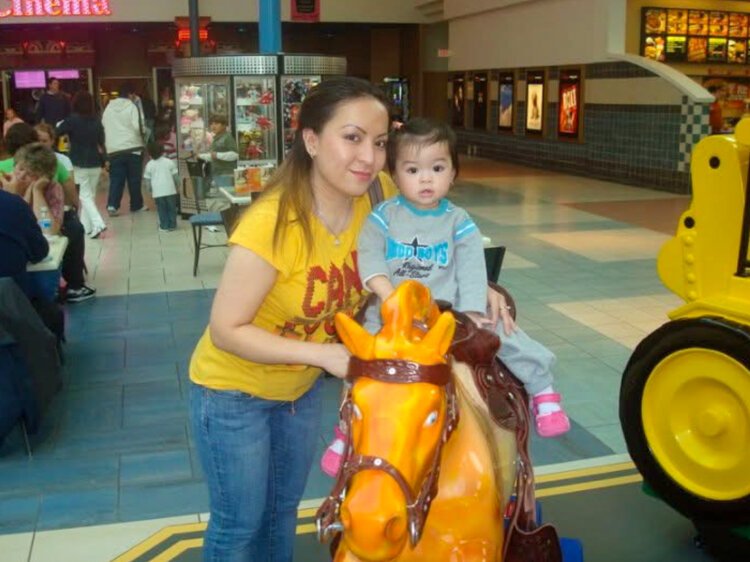 Two-year-old Jennifer Pham with her mother, Van Le, in front of the food court at Rivertown Crossings Mall in 2010.