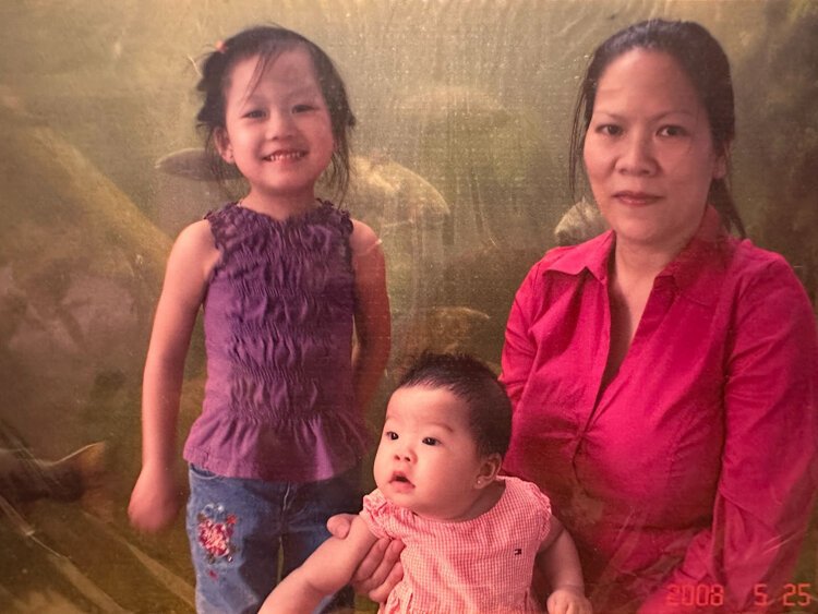 Christina Le as a young girl, pictured with her sister and mother.