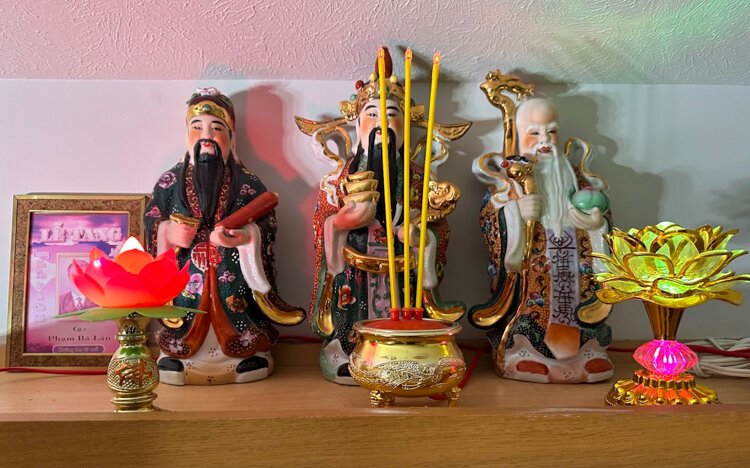 A Vietnamese altar in Christina Le's home honors her late maternal grandfather and features three statues symbolizing luck, wealth, and longevity.