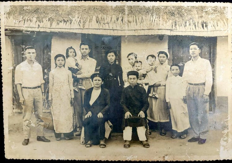 Amberly Nguyen's grandparents in Vietnam, posing for a family portrait alongside their parents and siblings.
