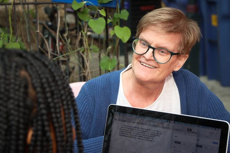 Mazonnah Holiday (foreground) speaks with teacher Tricia Kremke about how teachers work with students with learning differences.