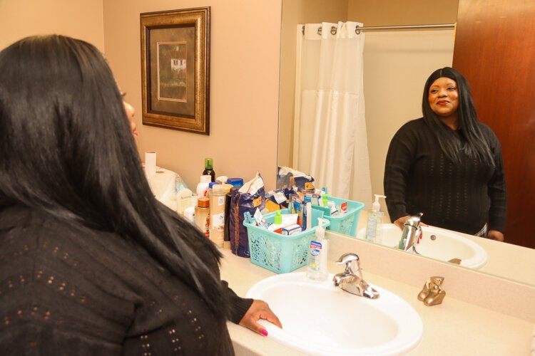 Bri smiles now, knowing that she no longer has to wait in line behind up to 20 other women to get a shower each morning