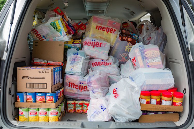 Constanza Terpstra's vehicle is stocked full of groceries and supplies for her clients.