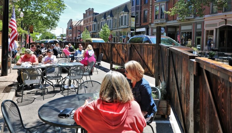 Volunteers built the 80-foot fence that allowed the Curragh Irish Pub to extend its patio.