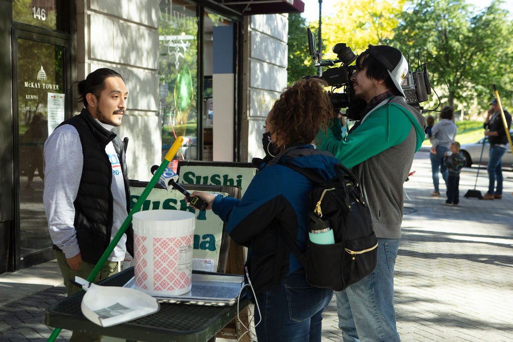 Volunteers talk to media on Monroe Center.