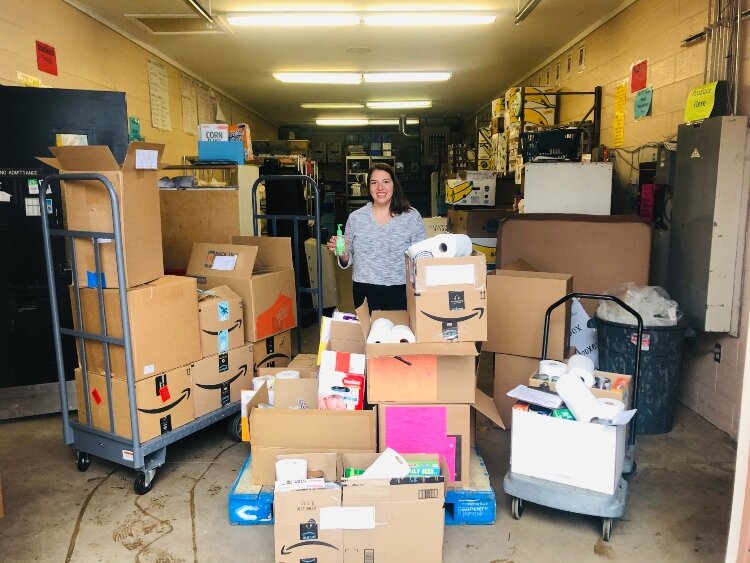 A CAH employees organizes donations that are being distributed to families in need.