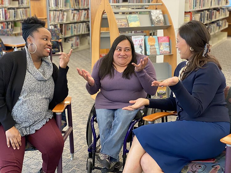 Women of Color GIVE cofounders Yah-Hanna Jenkins Leys, Lucia Rios, and Robyn Afrik talk about their work at Herrick District Library. Photo by Shandra Martinez