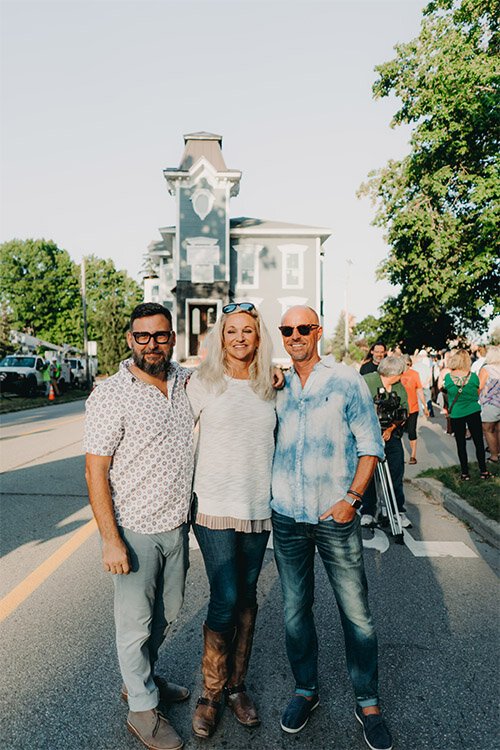 Robert Lopez and Patrick Roggenbau stand with their friend Spring Lake patron Kim Van Kampen.