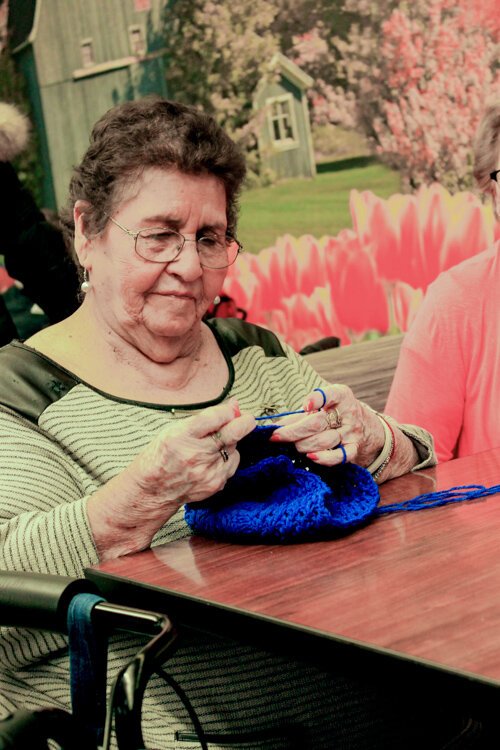 Petra Chavarria crochets and chats with friends on a recent afternoon at the LifeCircles PACE Hub in Holland Township.