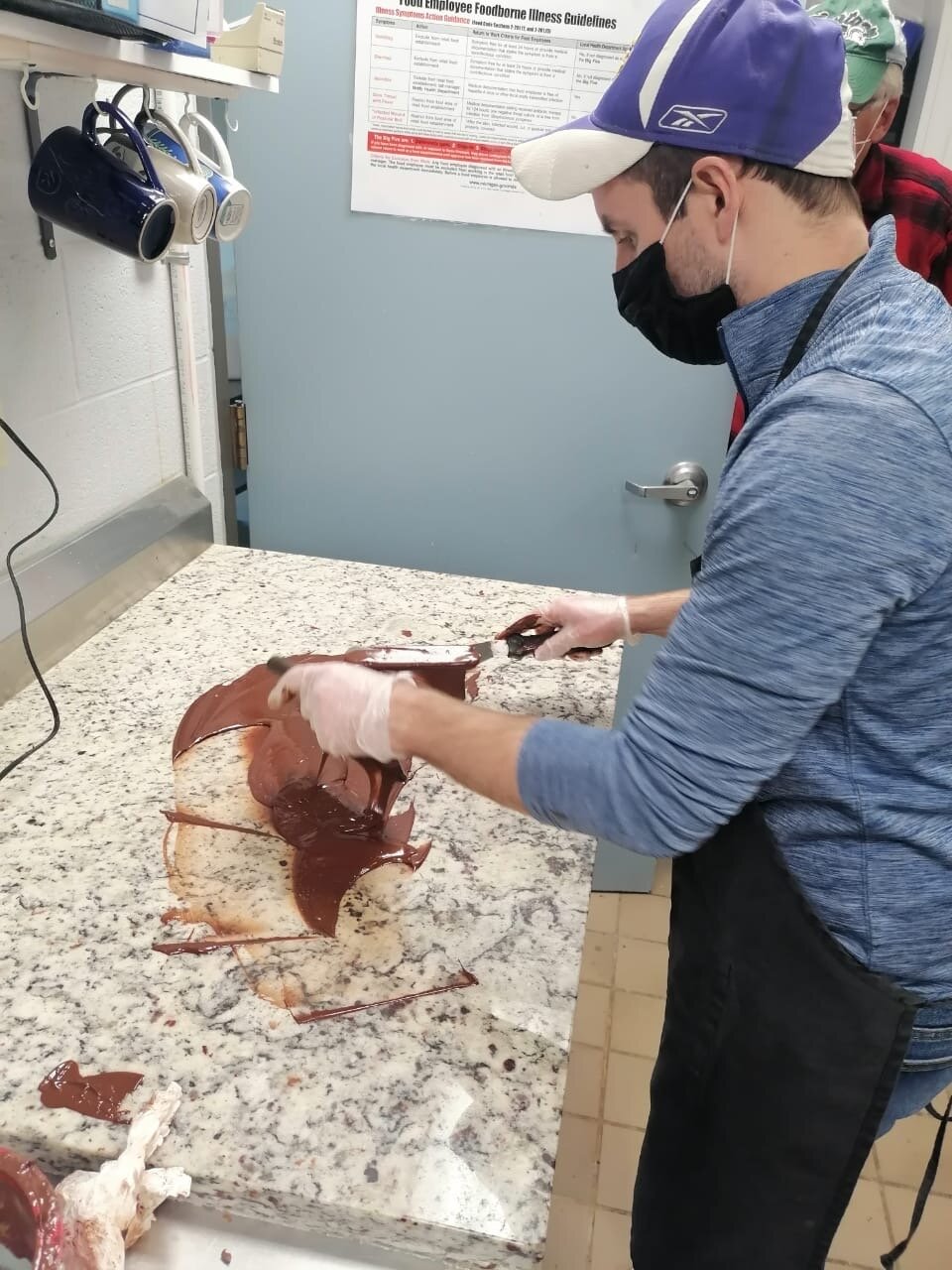 Roast Umber co-founder, Brad Gakenheimer, tempering refined chocolate for bar making at the commercial kitchen space (First Reformed Church) in Grand Haven