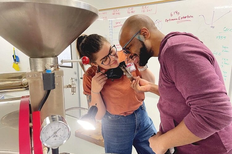 Arick Davis and Sarah Laman inspect equipment for their online coffee business.